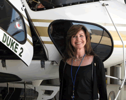 Grand Juror in front of helicopter